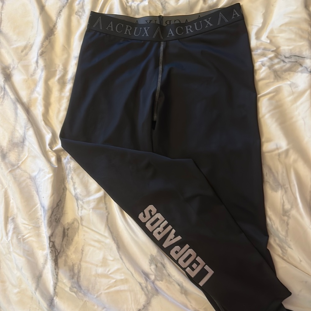 Acrux Black Spandex leggings with “Leopards” down the right leg.